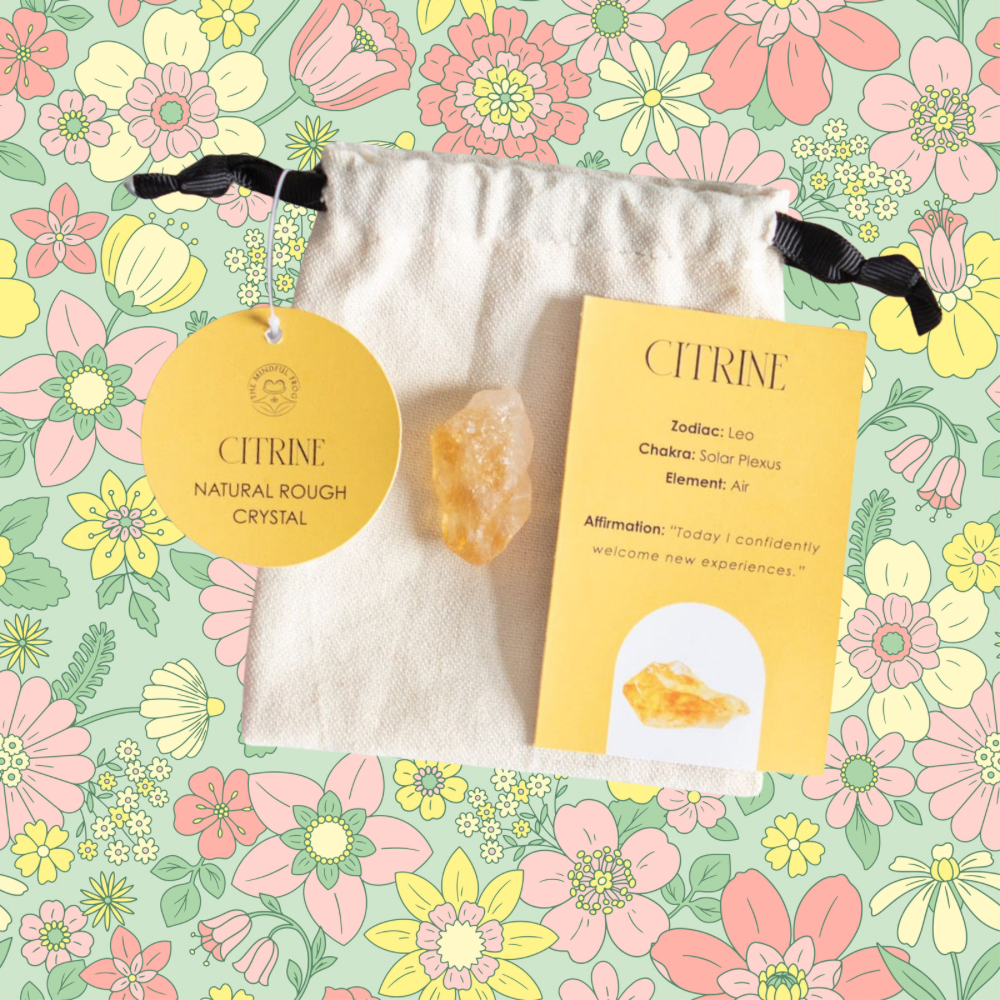 Citrine crystal presented in a soft cotton drawstring pouch with an information card, highlighting its properties for reducing tension and promoting a positive mindset.