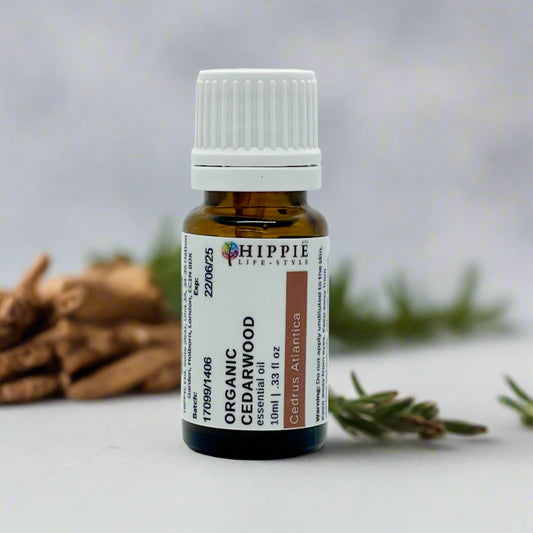Organic Cedarwood Atlas Essential Oil with leaves and twigs